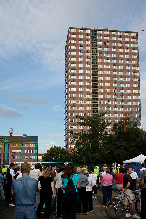 High-rise block, covered with paint barrels